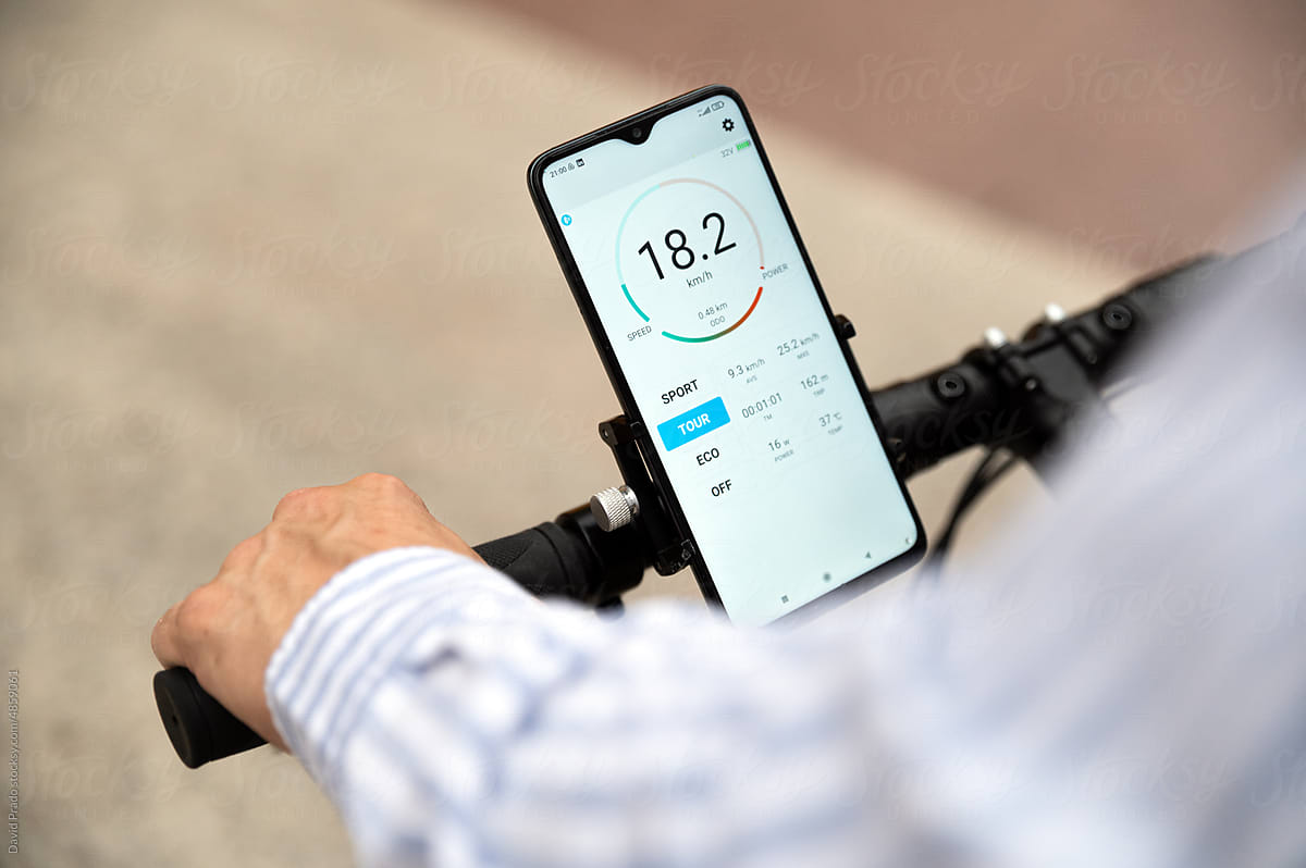 Crop bicyclist on bicycle with smartphone