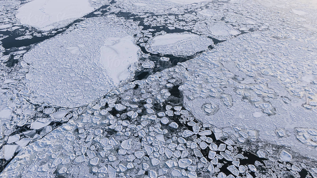 overhead view of a frozen river with ice flows