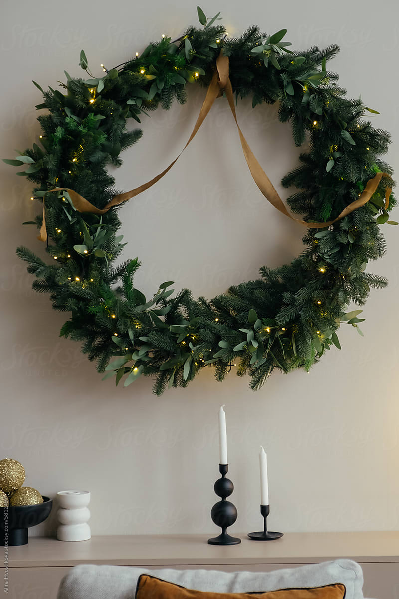 Christmas wreath hanging over candles