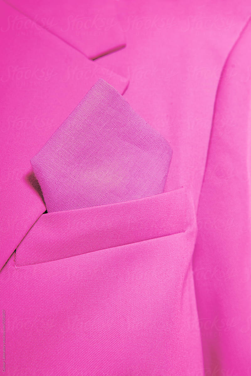Close-up of a person wearing pink blazer and tissue in a pocket