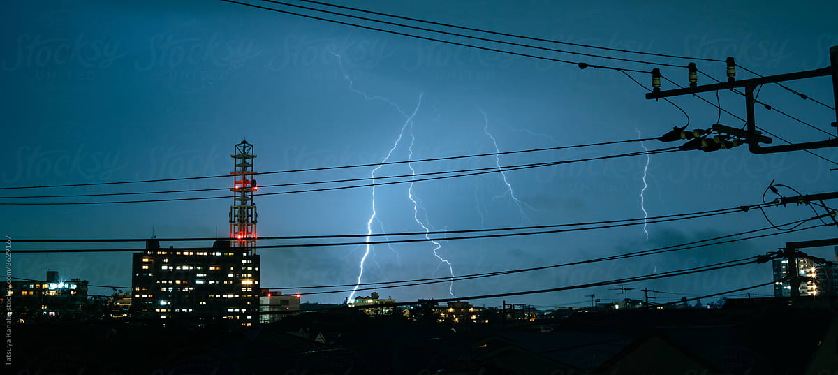 Electric wires during thunderstorm in city in Japan