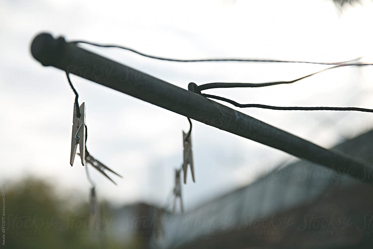shallow focus of pegs on a clothesline in early winter light