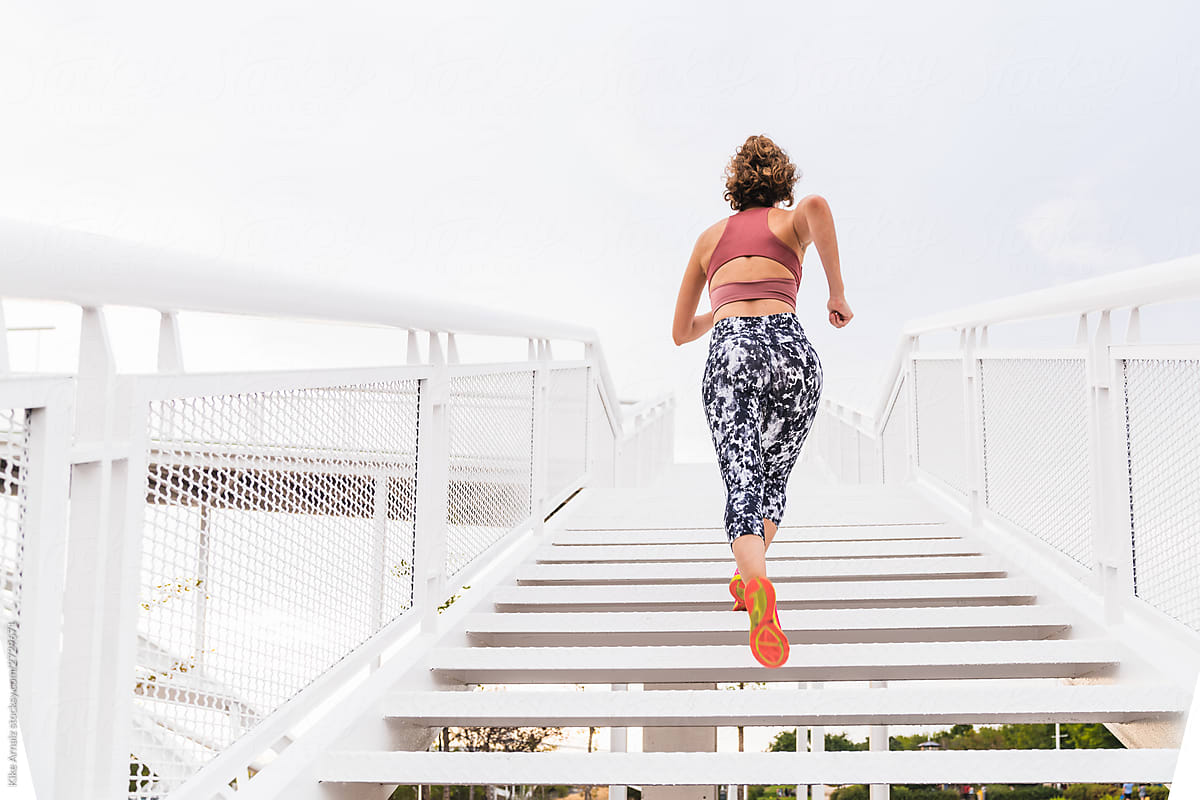 Young Fitness Woman running up the stairs.