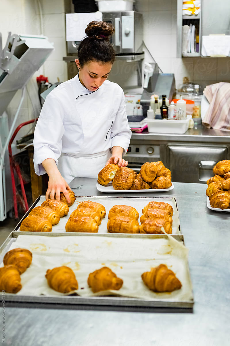 Young Pastry Chef Sorting Freshly Baked Croissants