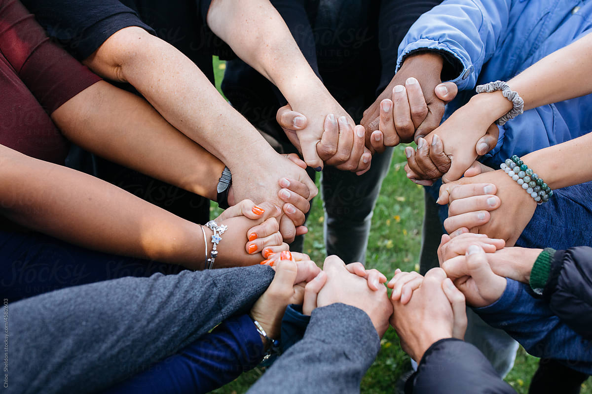 Diverse Group of People Holding Hands in a Circle