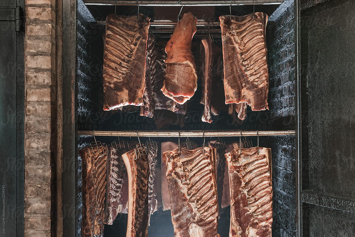 Meat smoking chamber full of aged meat cuts