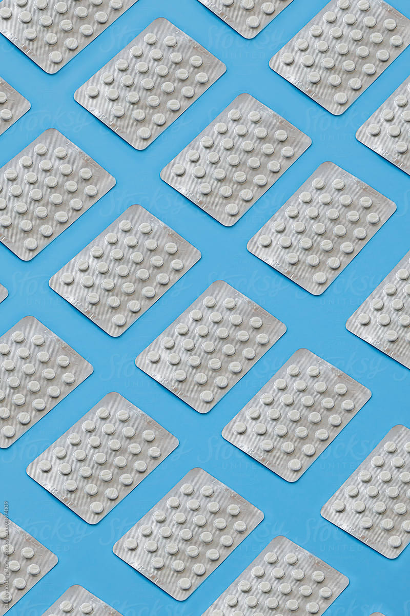 Blister Pills Patterned On Soft Blue Background