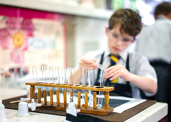 Young Boy Doing A Science Experiment At School by Stocksy Contributor Angela  Lumsden - Stocksy