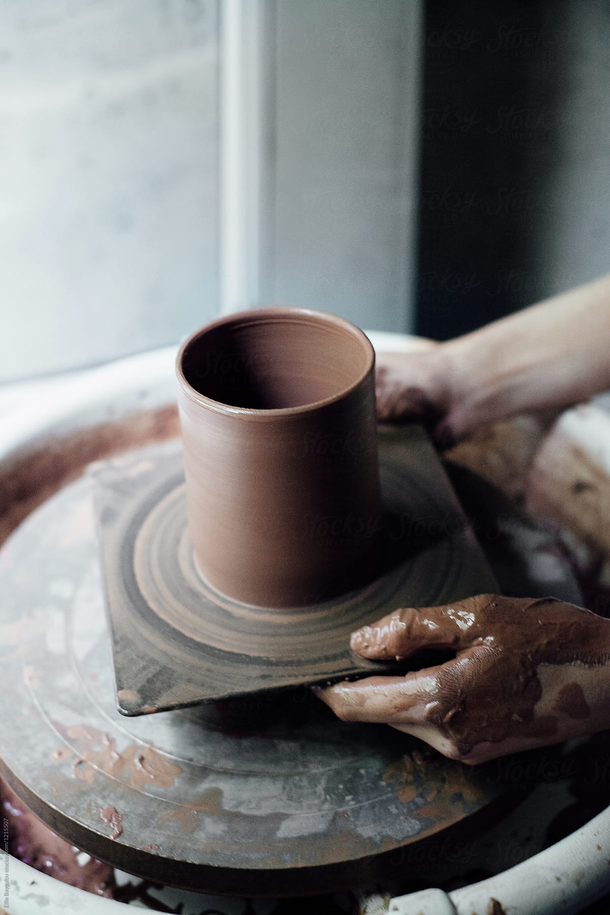 Woman making pottery in her studio