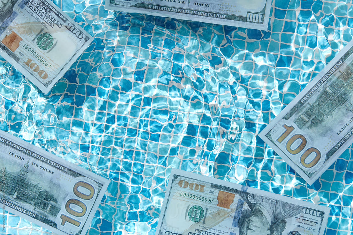 100 dollar banknotes gliding across pool water surface.