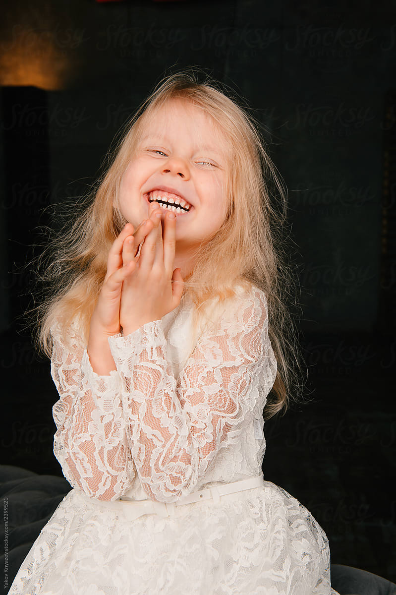 Cute Little Blond Girl Emotional Portrait Against Dark Background By 