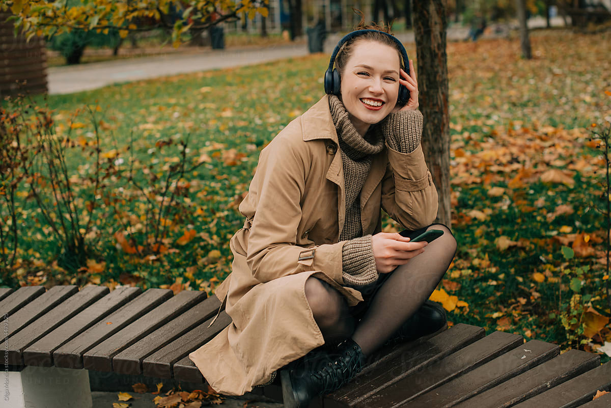 Woman listening to music in the autumn park