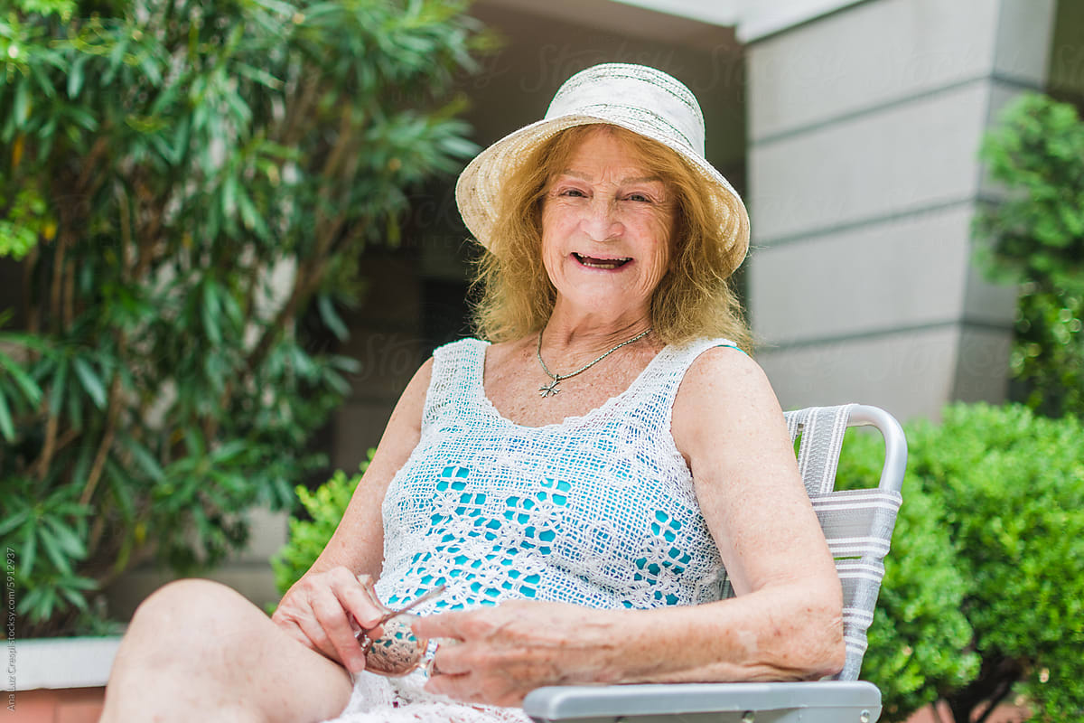 Cool senior woman laughing outdoors portrait