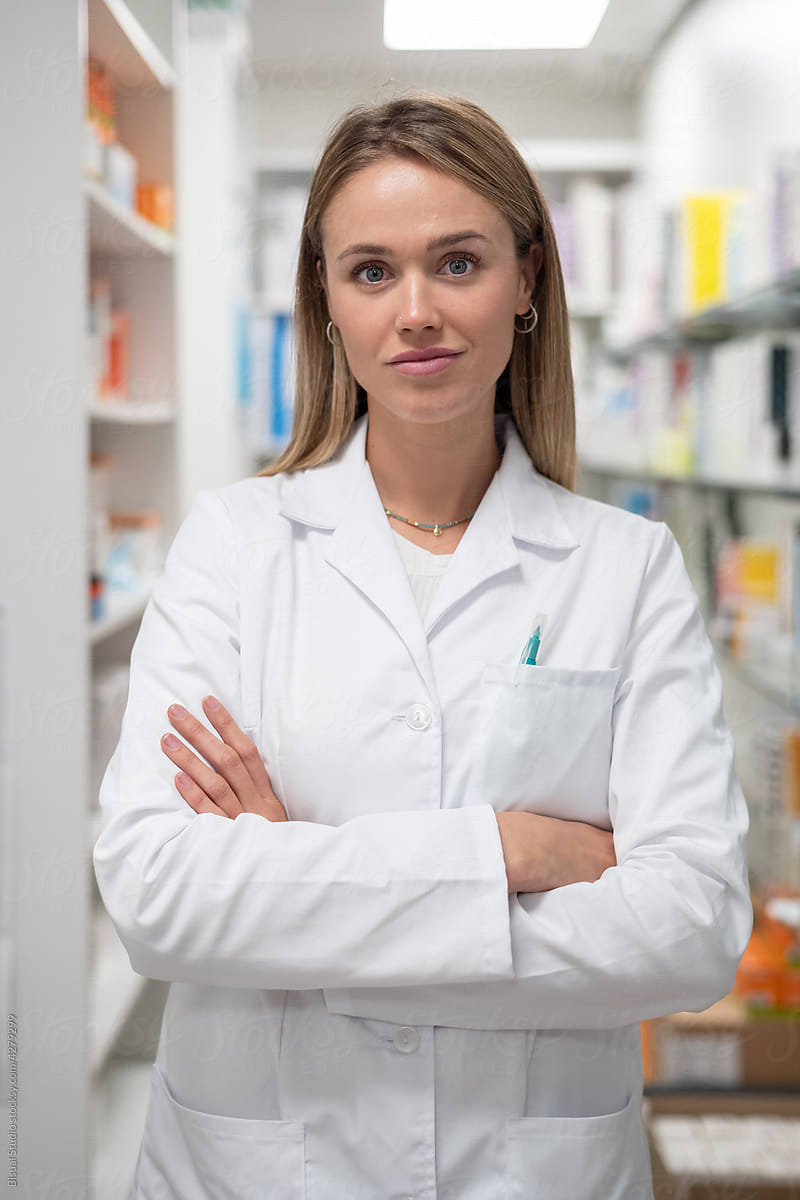 Pharmacist folding hands in drugstore