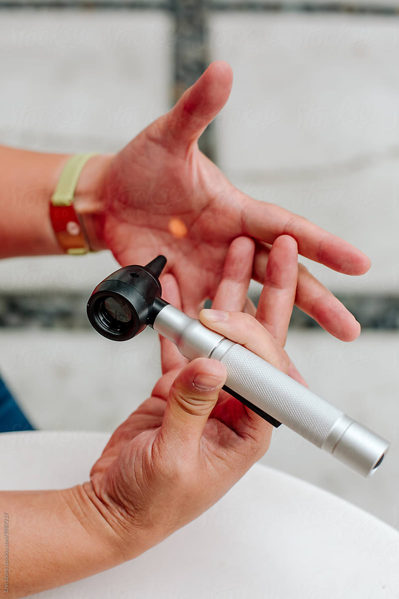 Close-up of hands holding otoscope