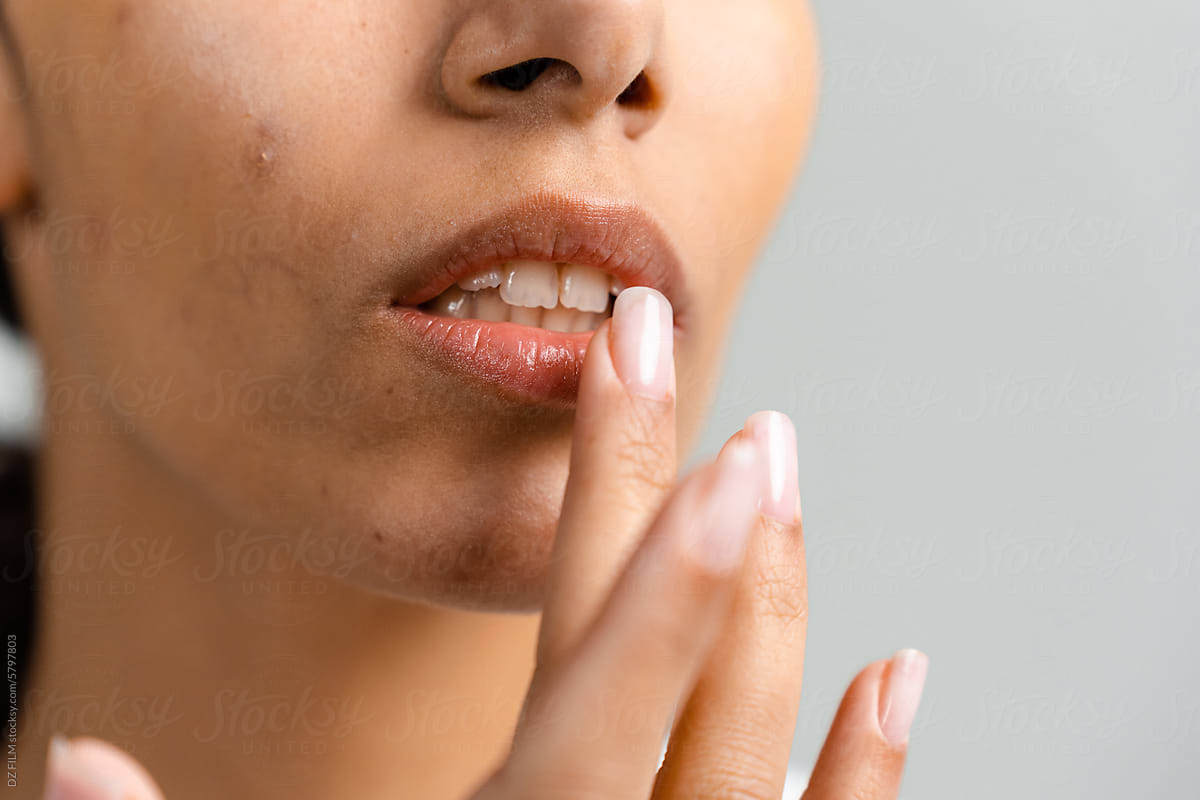 A woman uses hygienic lipstick