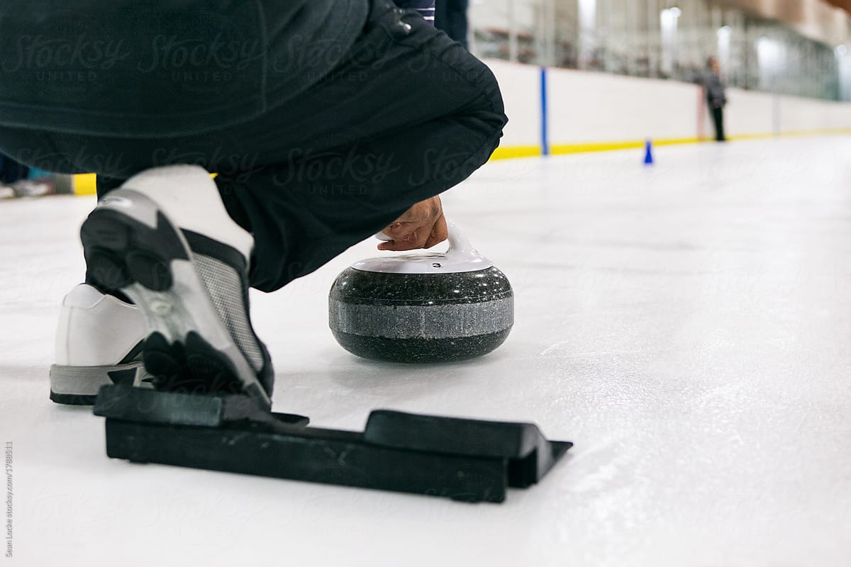 Curling: Thrower About To Release Stone Down Sheet