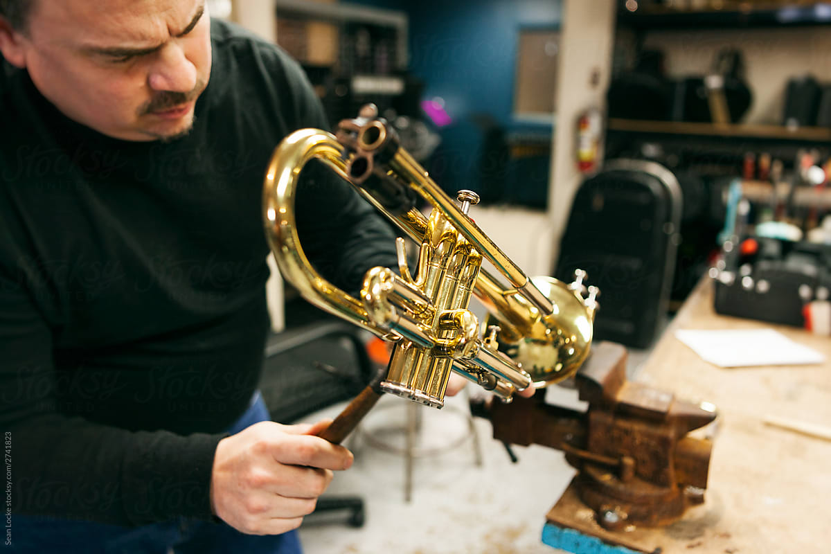 Band: Man Disassembles Trumpet In Workshop