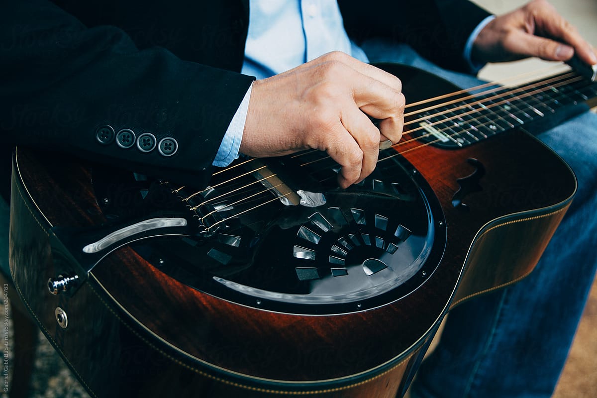 Closeup of A Male Musician\'s Hands Playing Slide Guitar