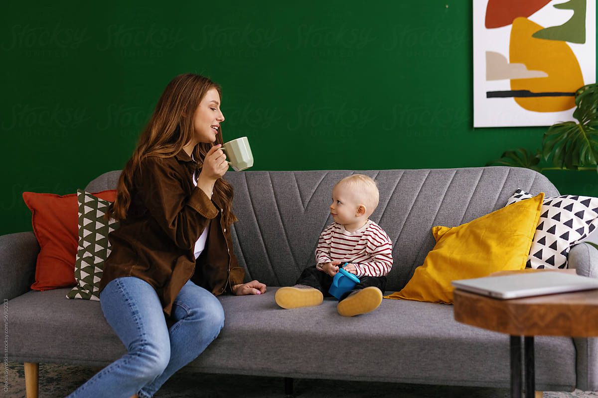 Parent-child relation settee home babyhood drink babysitting mother