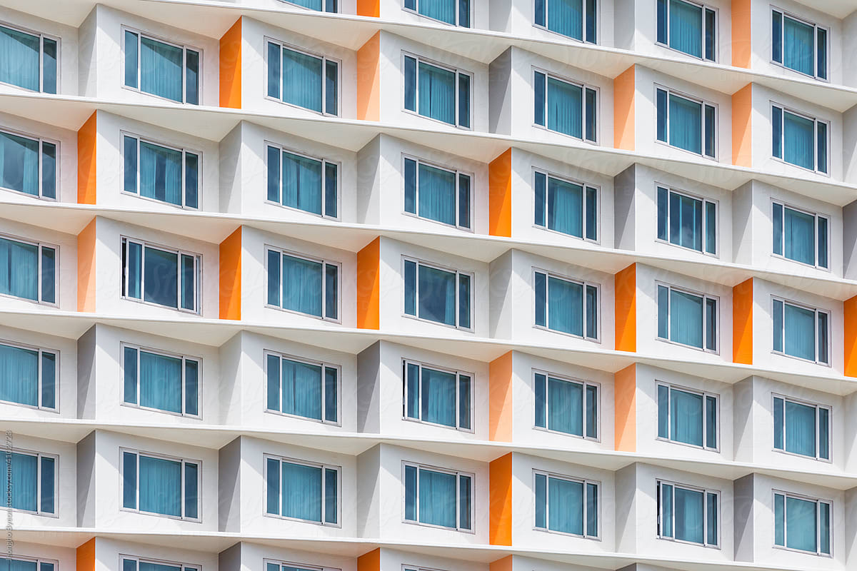 Numerous windows of buildings painted orange.