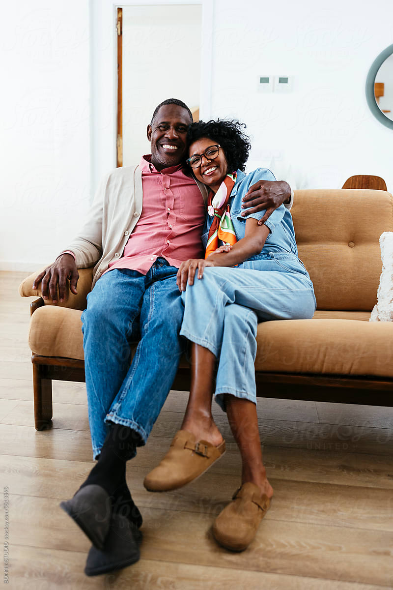 Cheerful couple portrait in a bright home