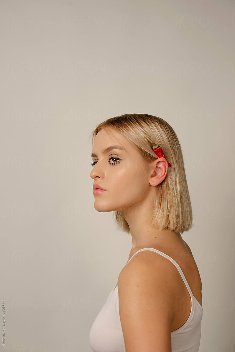 Profile View of a Young Woman With red hot pepper