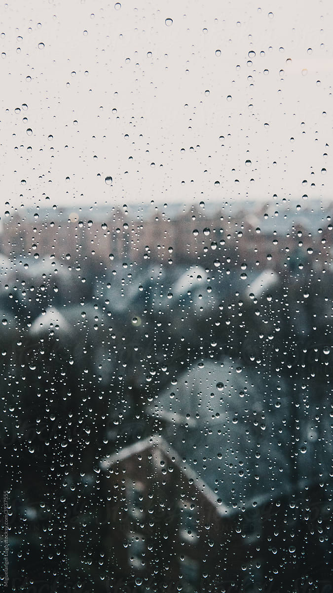 Rain Droplets on a Window Overseeing the City