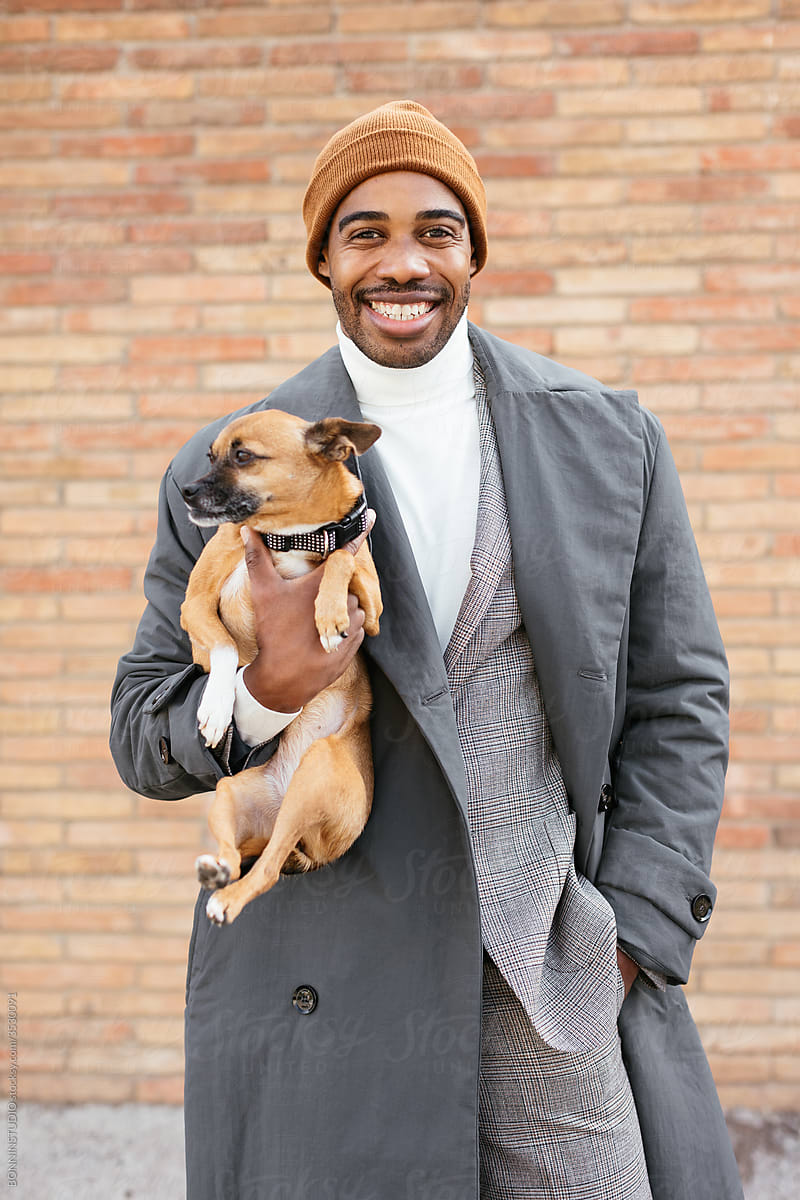 Happy stylish black guy with dog