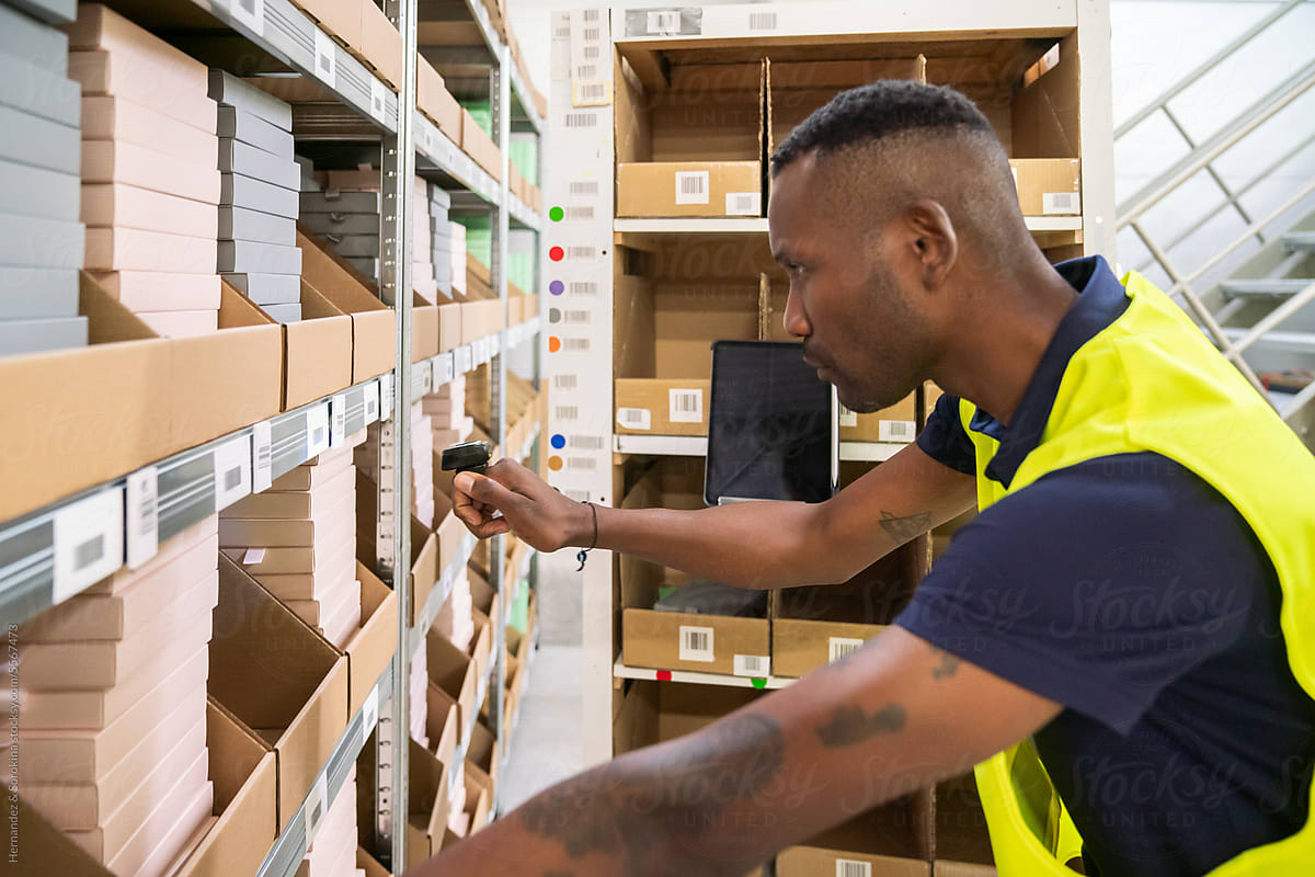 Worker Scanning Goods At Warehouse Storage