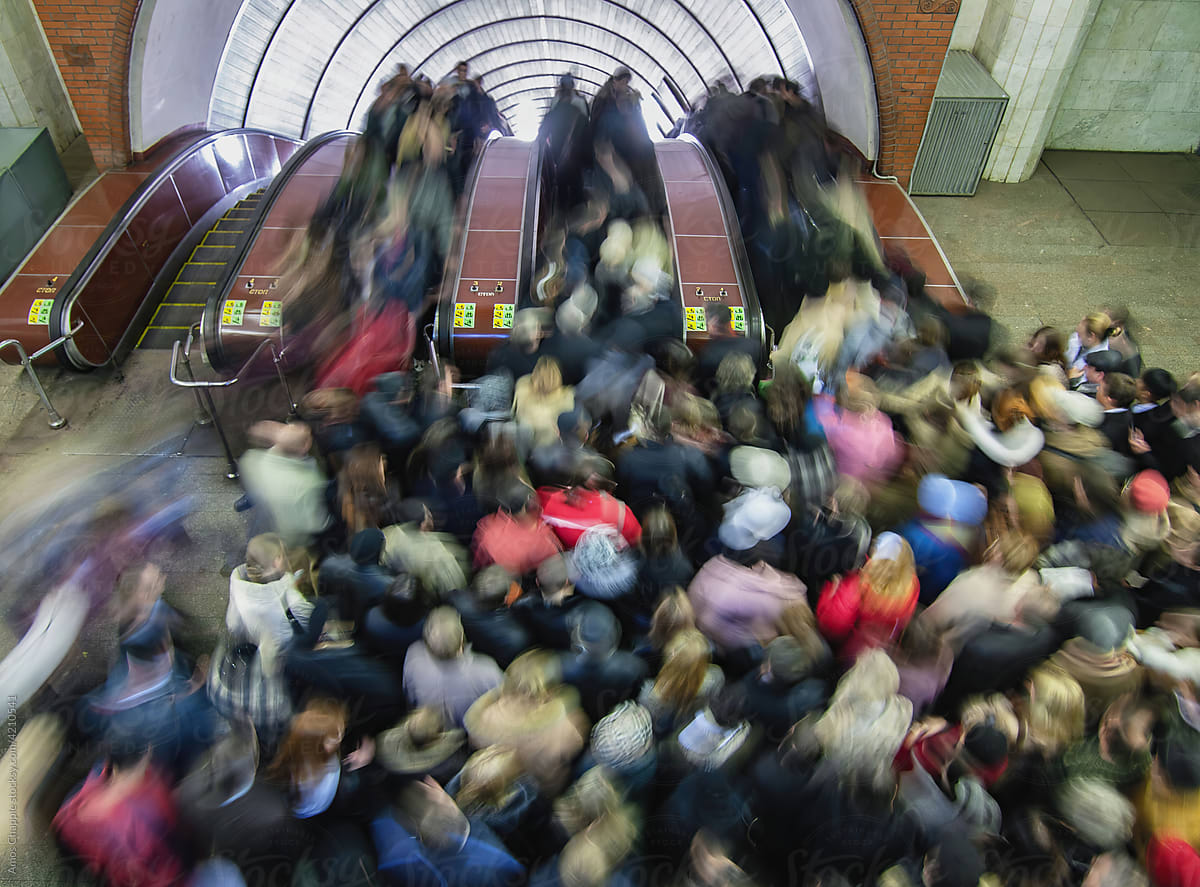 A crowd of commuters squeeze onto an escalator in the Moscow Metro.