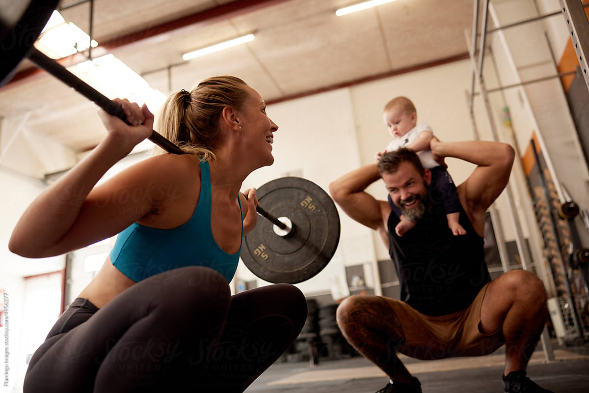 Smiling woman weightlifting with her family