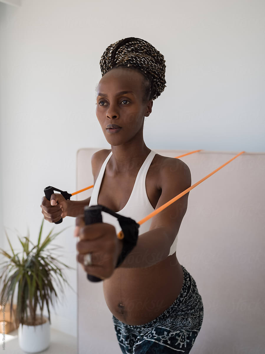 African pregnant lady training with tube band
