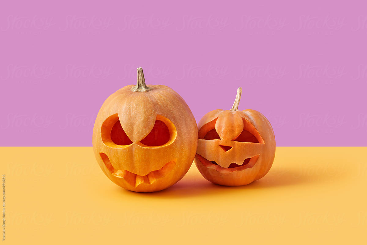 Halloween pumpkins on pink and yellow background.