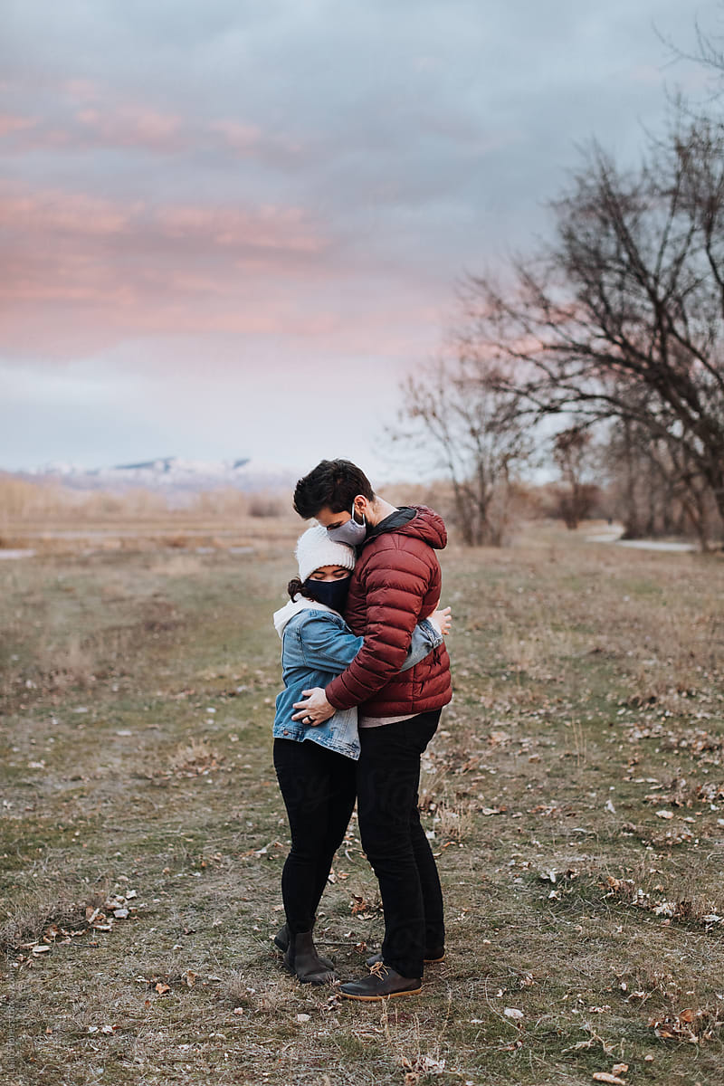 Couple Hugging in Park at Sunset