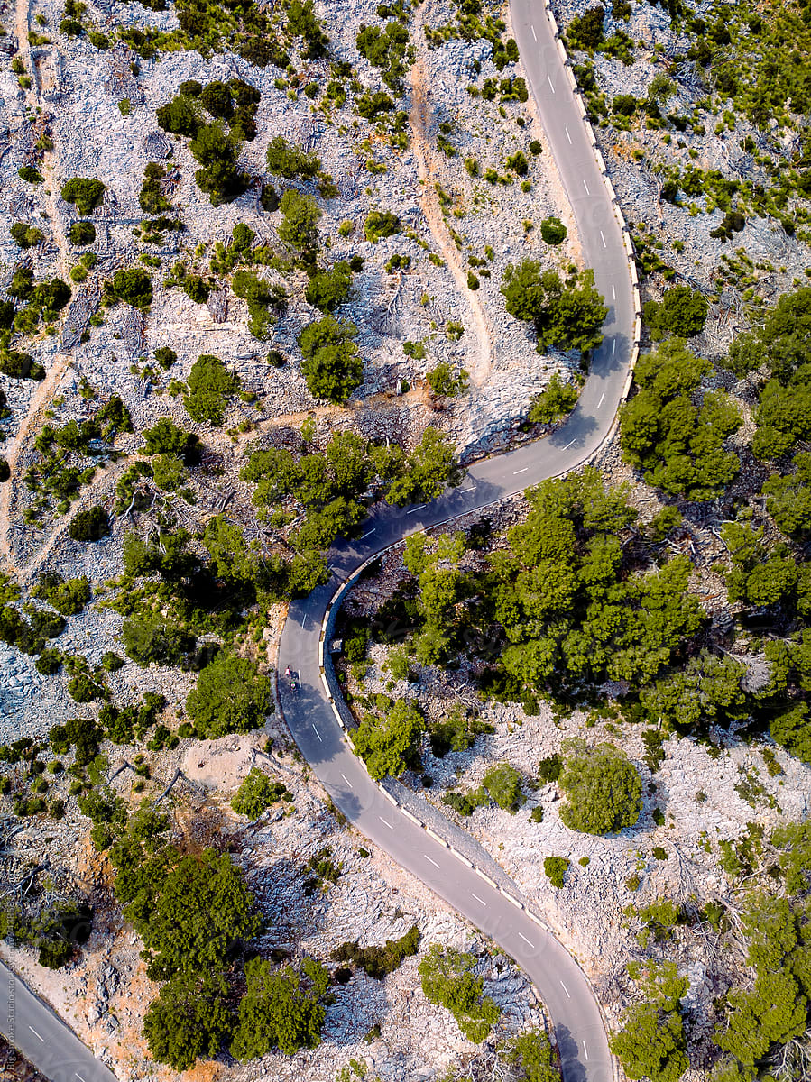 Cyclists in the Mountains on the road seen from the Drone.
