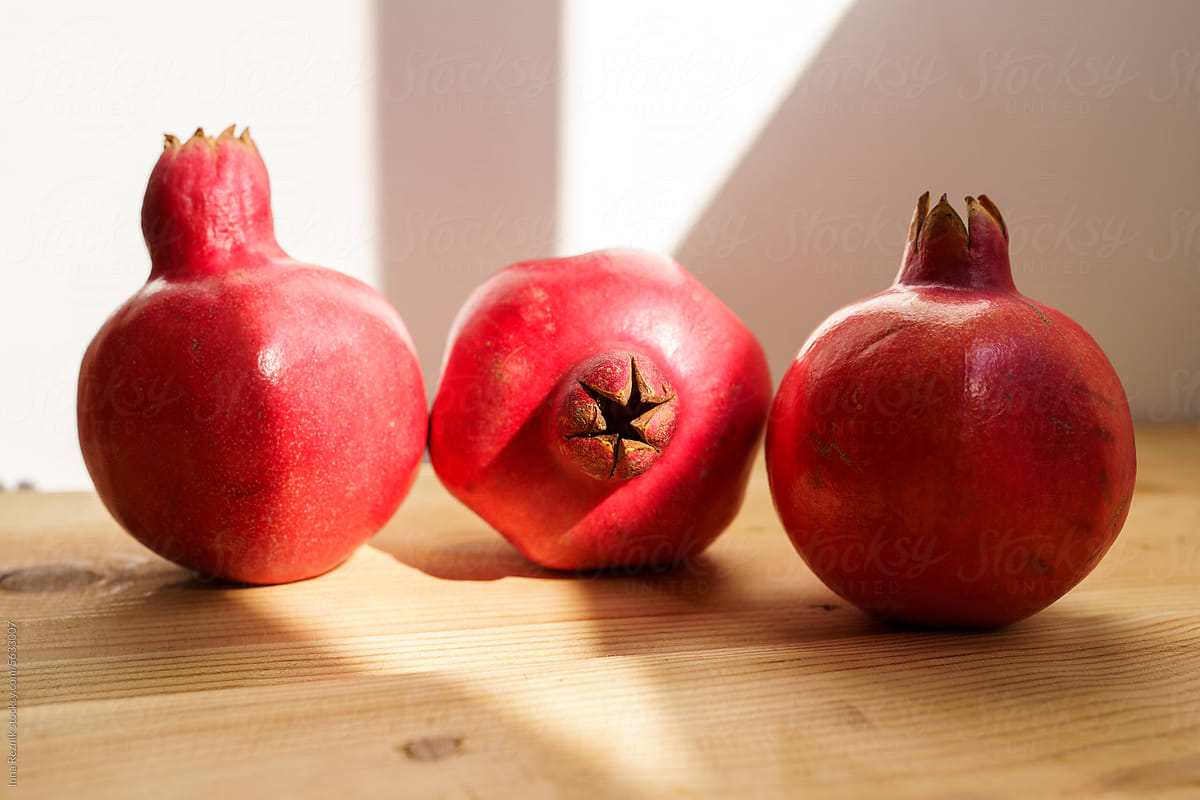 Rosh Hashanah Symbols. Three Pomegranates in Sunlight.