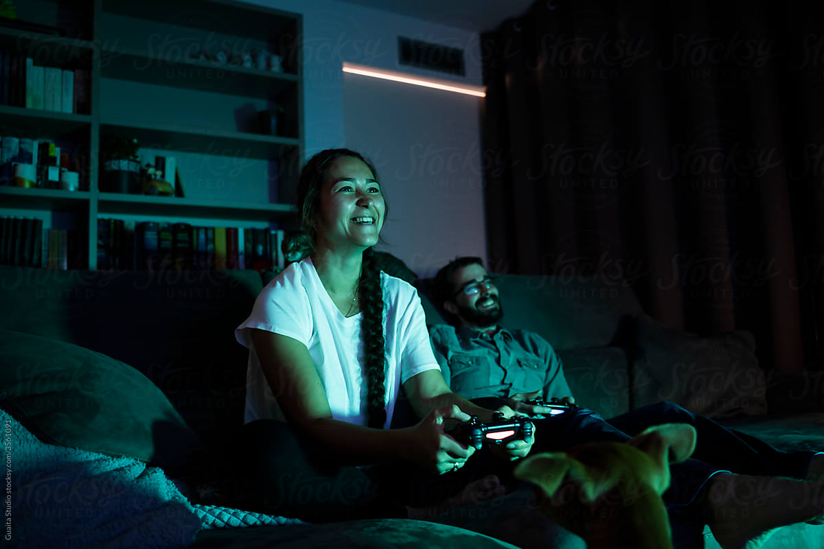 Young couple watching movie and playing video games