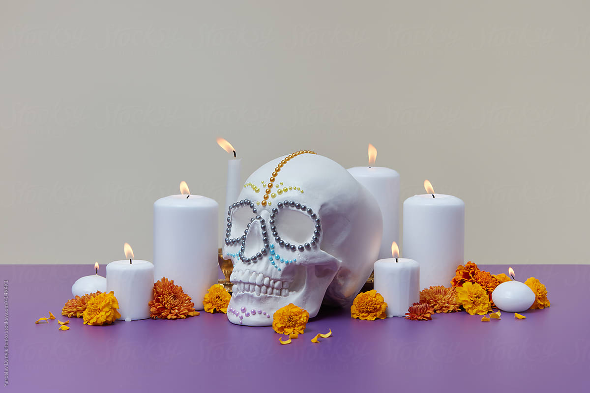 Skull with candles, beads and flowers
