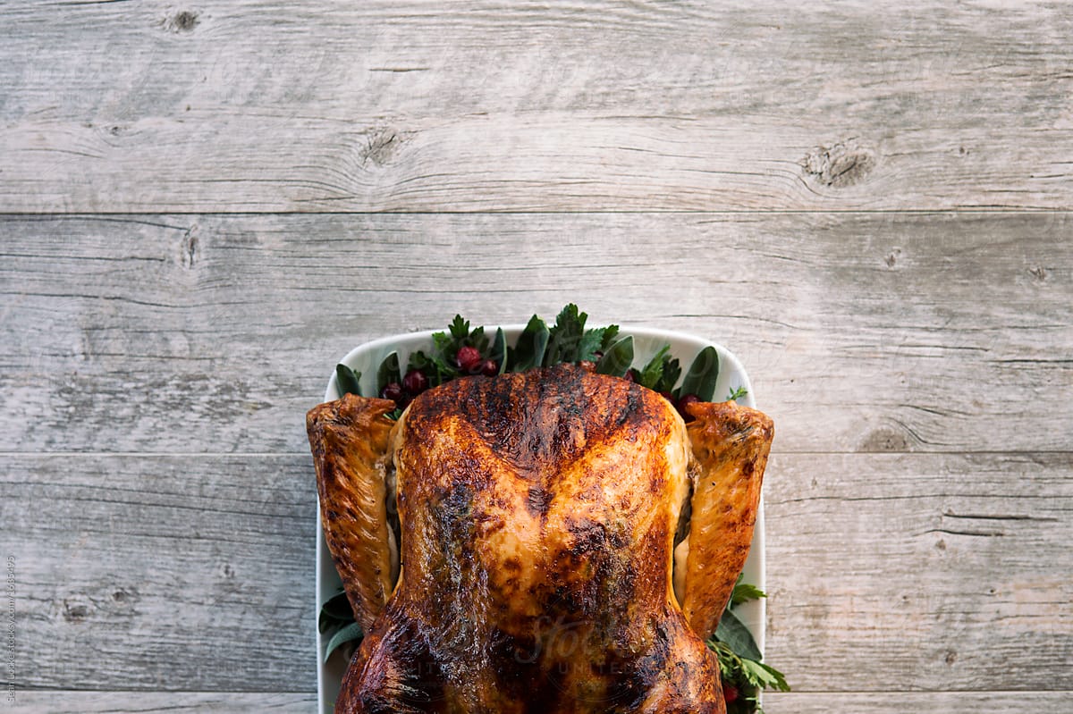Thanksgiving: Delicious Turkey With Aromatics On Wooden Table