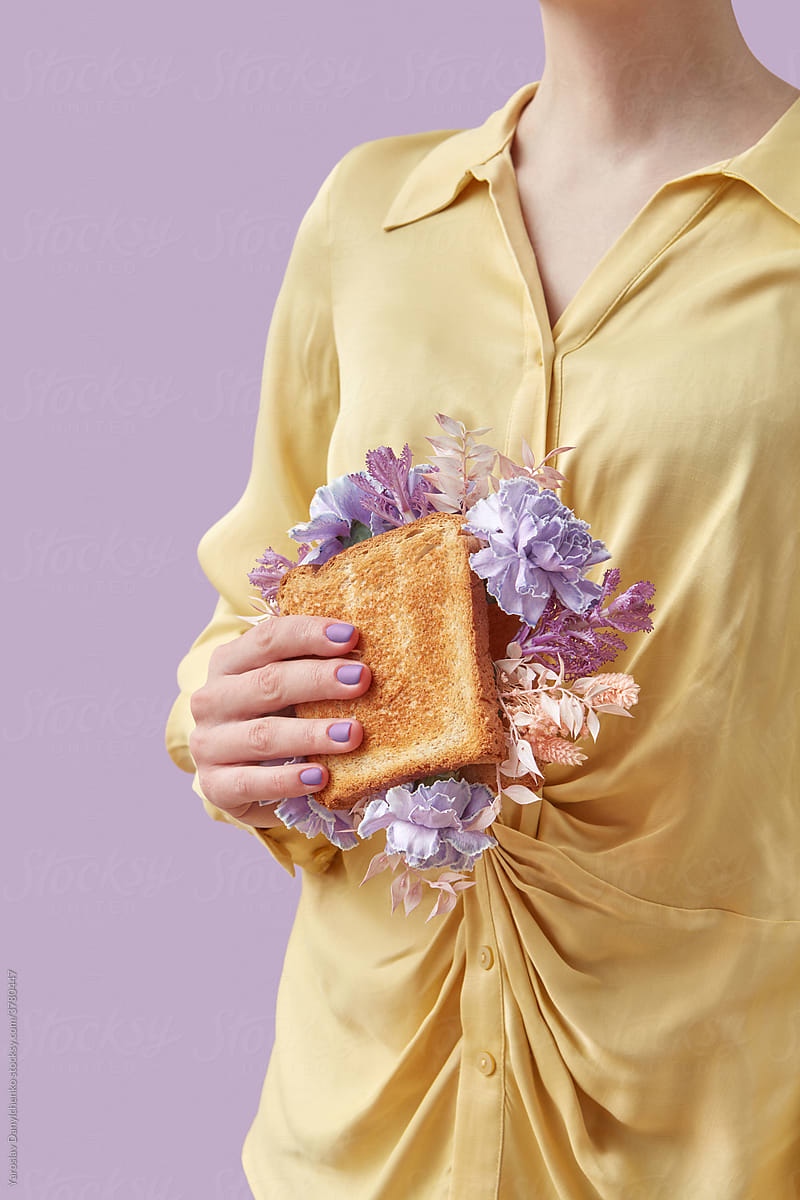 Girl holding sandwich with purple flowers