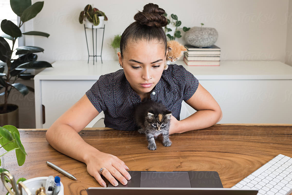 Teenager on computer with kittens.