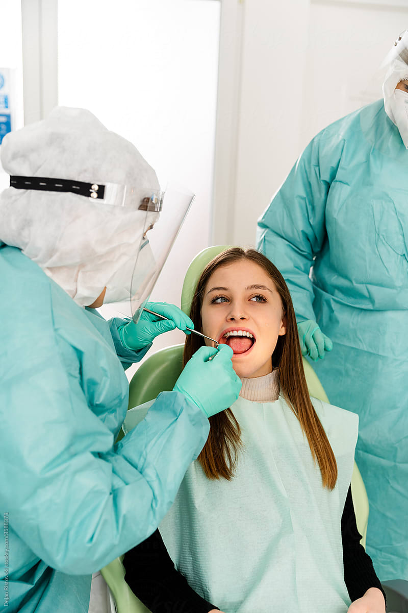 Dentist and assistant working on a patient in dentist clinic