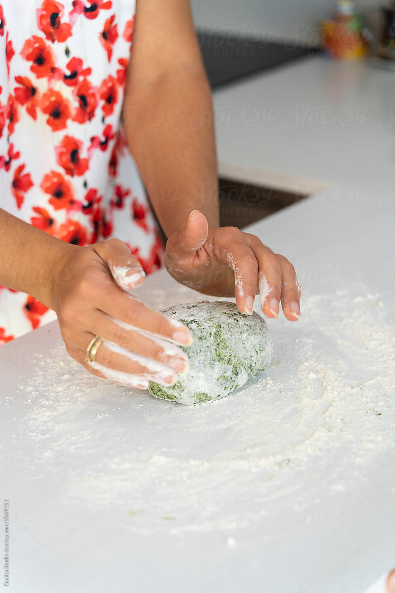 Closeup of hands of Young woman making pasta dough