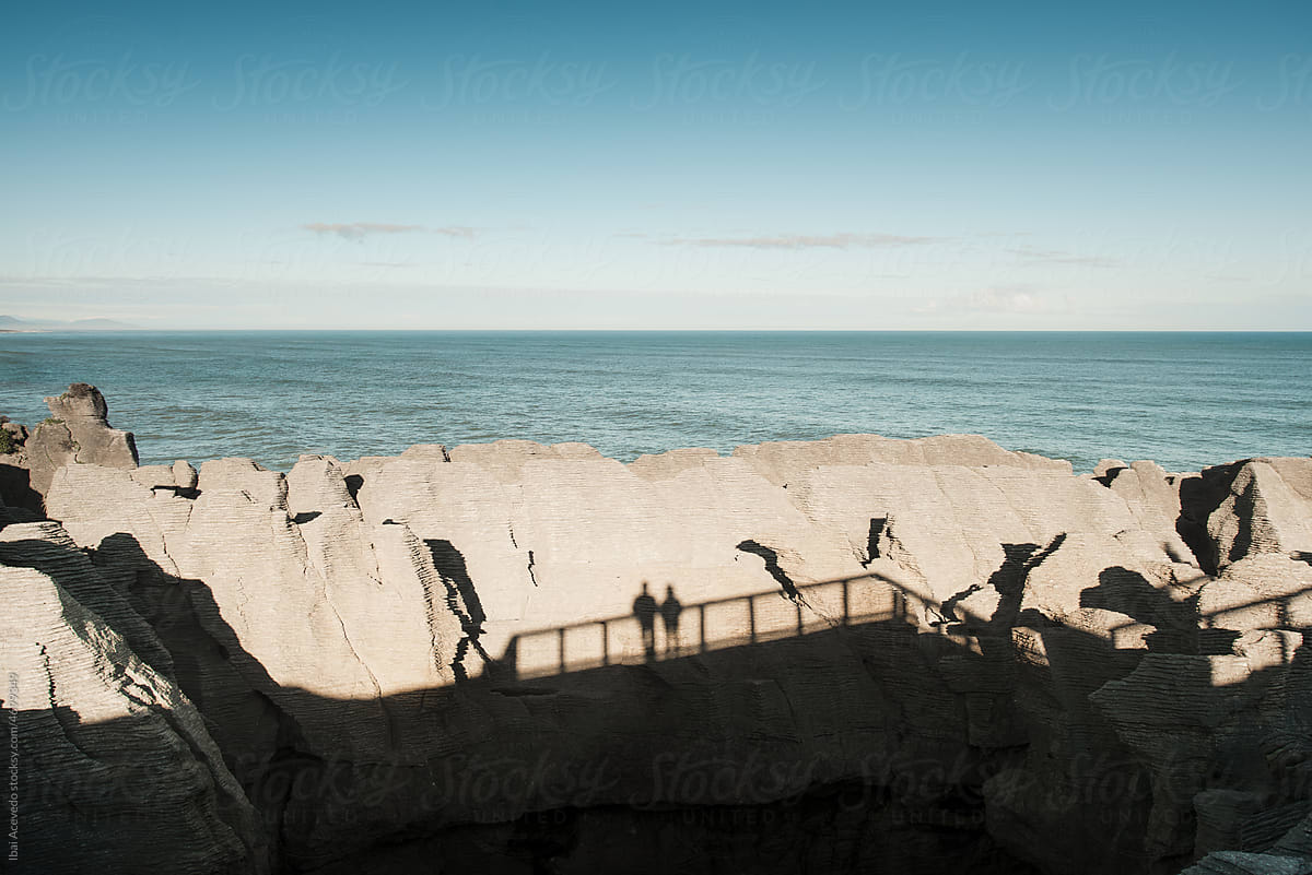 Human shadows on strange cliff rocks