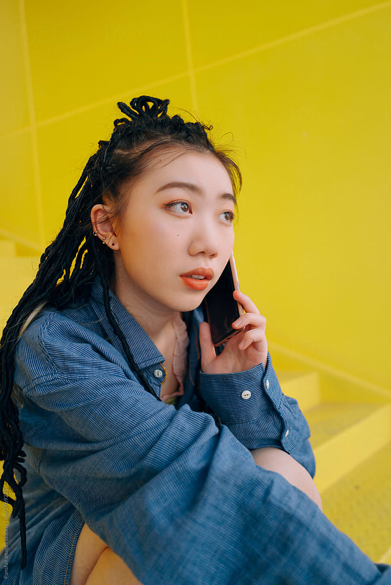 Fashion young Asian woman calling by mobile phone