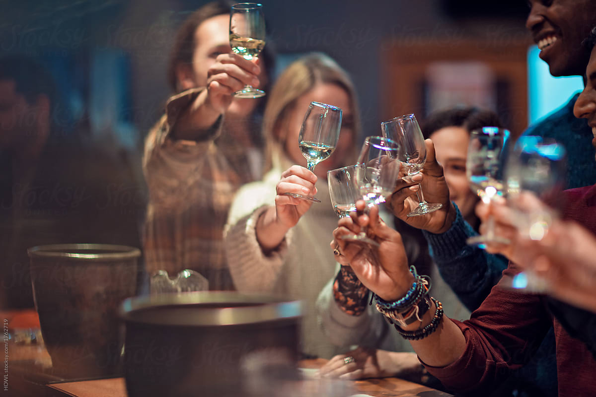 Group of friends toasting during and having a great time during a wine tasting event
