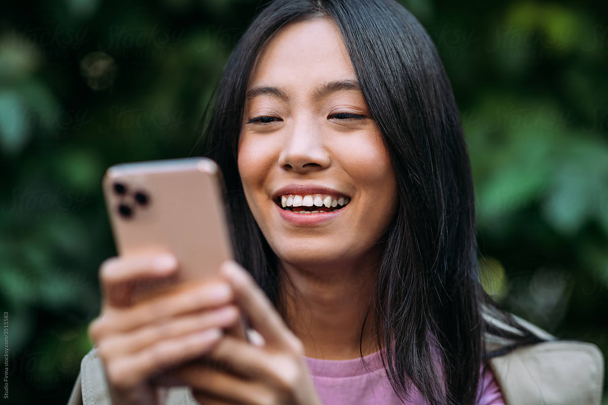Close up of an Asian Woman Using a Mobile Phone