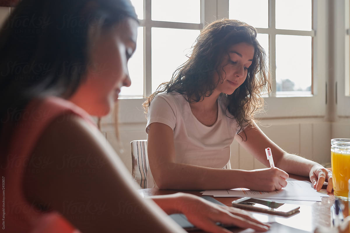 Two Flatmates Doing Homework By Stocksy Contributor Guille Faingold Stocksy 3544