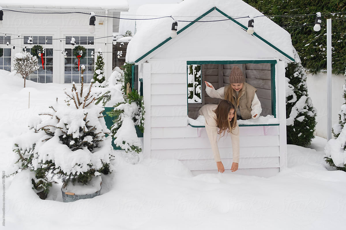 Happy girls playing in winter in tiny house